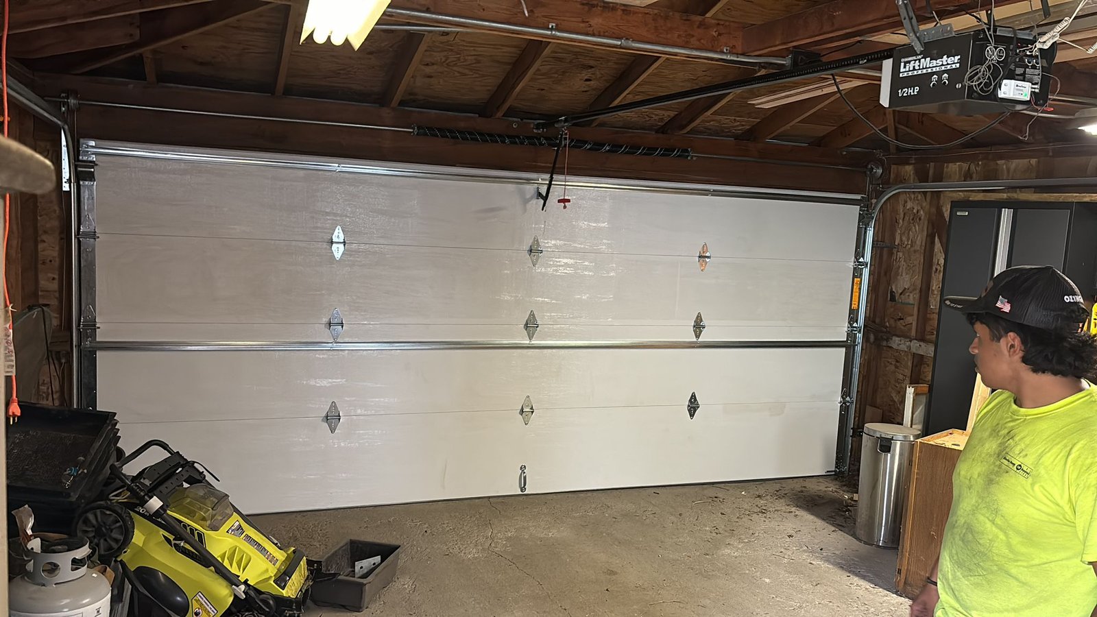 Technician repairing a residential garage door