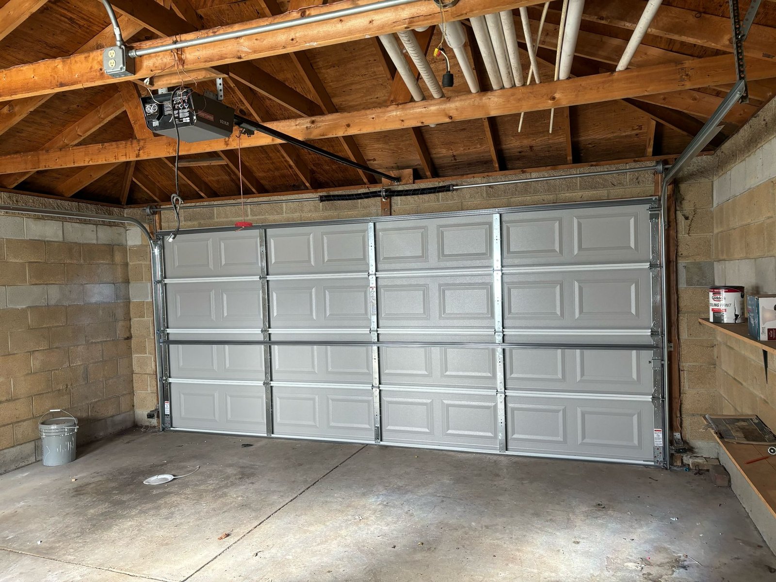 Professional technician installing new garage door system
