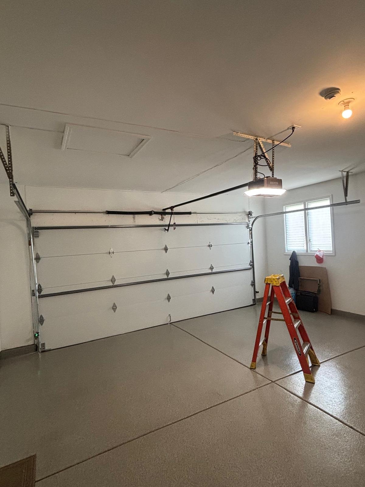 Garage door repair Waukegan IL — certified technician replacing corroded springs on lakefront home near Glen Flora